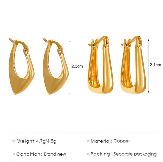 Gold asymmetrical huggie pair of earrings