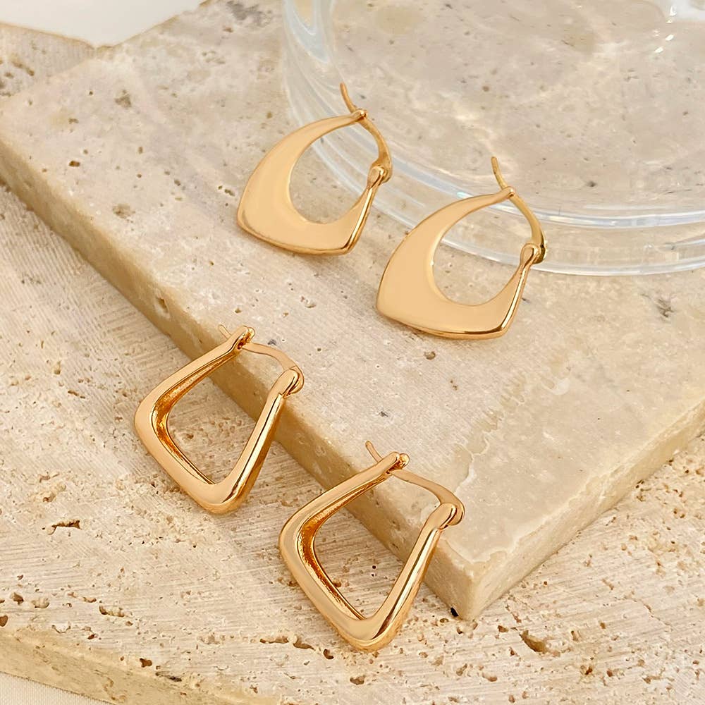 Gold asymmetrical huggie pair of earrings