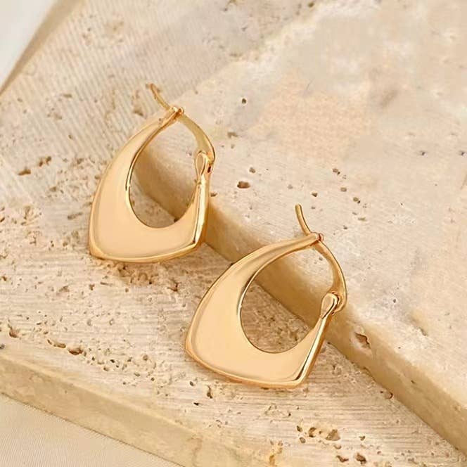Gold asymmetrical huggie pair of earrings